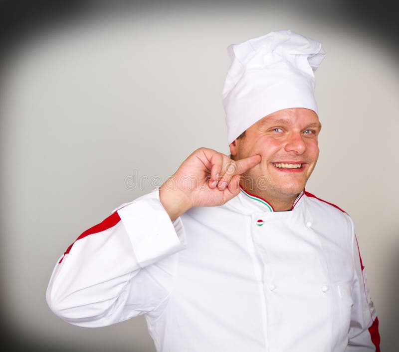 Een Glimlachende chef-kok royalty-vrije stock afbeeldingen Een Glimlachende chef-kok royalty-vrije stock afbeeldingen