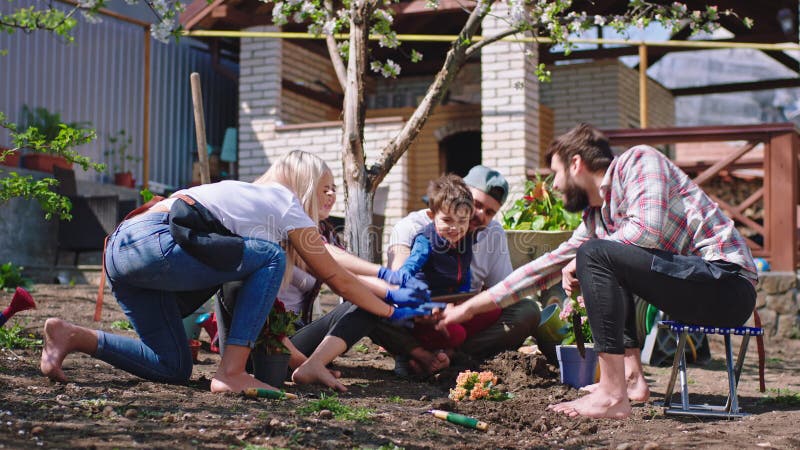 Een goed vriendschappelijk team in de tuin , jonge vrienden , nadat ze klaar waren met het planten van de bloemen die ze overhandi