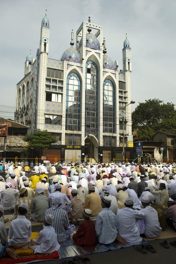 A group of Muslim Young men are sitting in a queue on road at Eid prayer in front of a mosque in Kolkata. A group of Muslim Young men are sitting in a queue on road at Eid prayer in front of a mosque in Kolkata