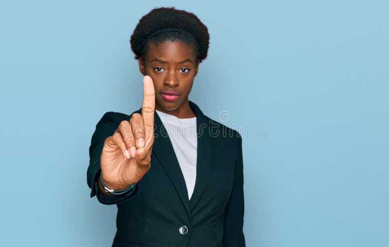 Young african american girl wearing business clothes pointing with finger up and angry expression, showing no gesture. Young african american girl wearing business clothes pointing with finger up and angry expression, showing no gesture