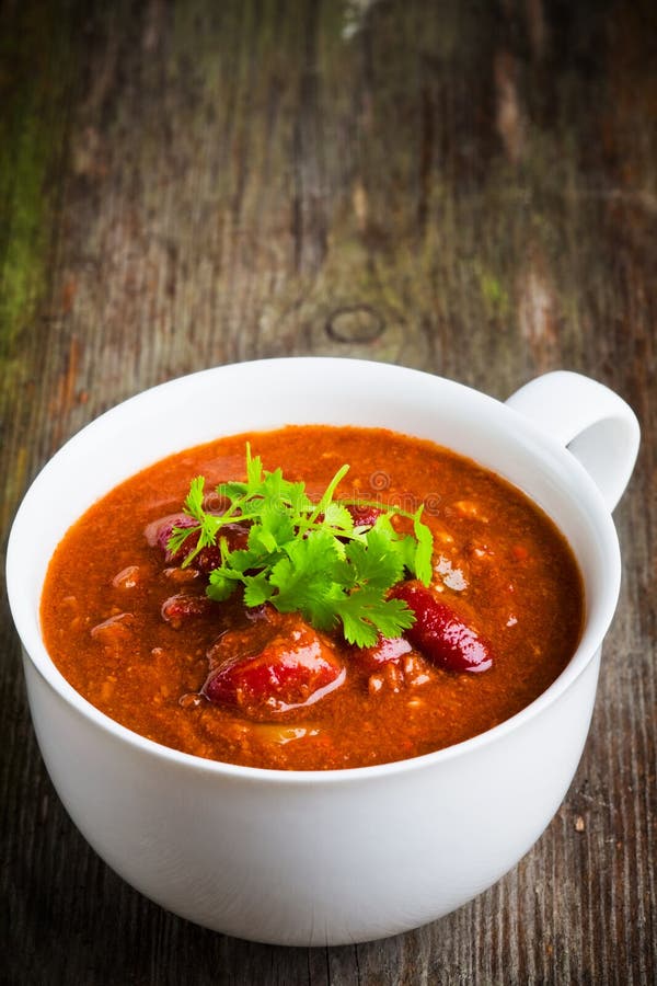 A cup of chili con carne with coriander. A cup of chili con carne with coriander