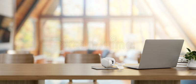 A back view image of a laptop computer, headphones, and decor on a wooden table in a comfortable farmhouse living room. home workspace concept. 3d render, 3d illustration. A back view image of a laptop computer, headphones, and decor on a wooden table in a comfortable farmhouse living room. home workspace concept. 3d render, 3d illustration