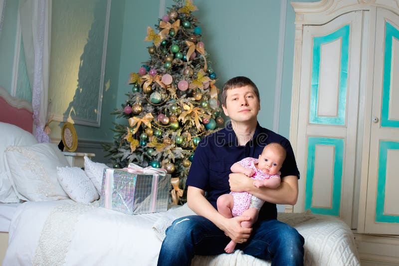 Een mens met een kleine dochter op handen Kerstmis ruimte stock foto Een mens met een kleine dochter op handen Kerstmis ruimte stock foto