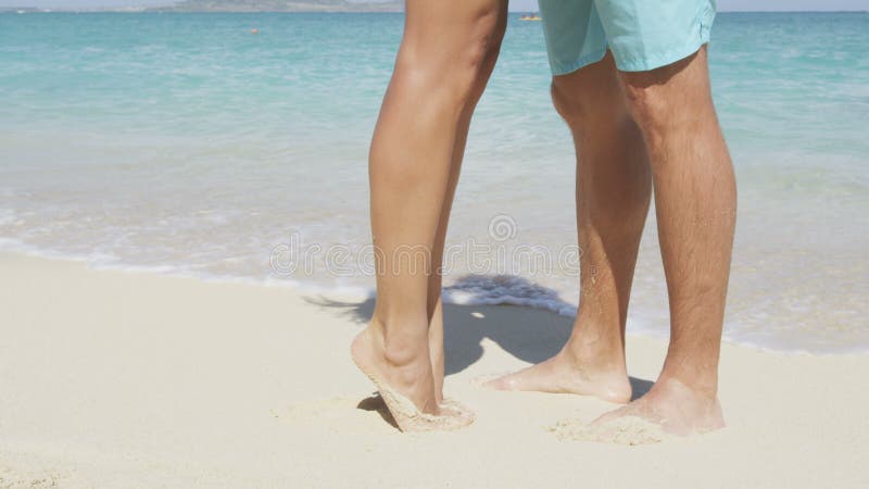 Een paar zoenen op het strand in een romantische emmer