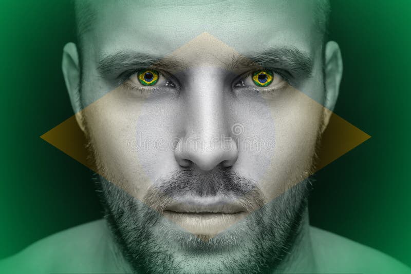 Een portret van een jonge ernstige mens, in van wie ogen de nationale vlag wordt weerspiegeld royalty-vrije stock foto's Een portret van een jonge ernstige mens, in van wie ogen de nationale vlag wordt weerspiegeld royalty-vrije stock foto's