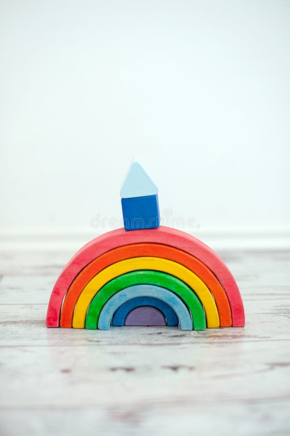 A wooden rainbow with a cubbyhole on it. A wooden rainbow with a cubbyhole on it