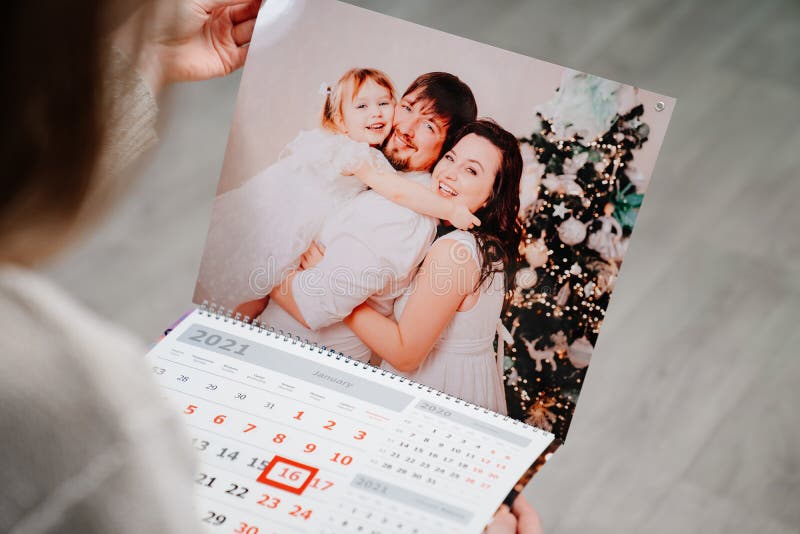 Het formulier uitzetten Auckland Een Vrouw Kijkt Naar Een Kalender Met Een Familiefoto. Stock Afbeelding -  Image of papa, familie: 213373871