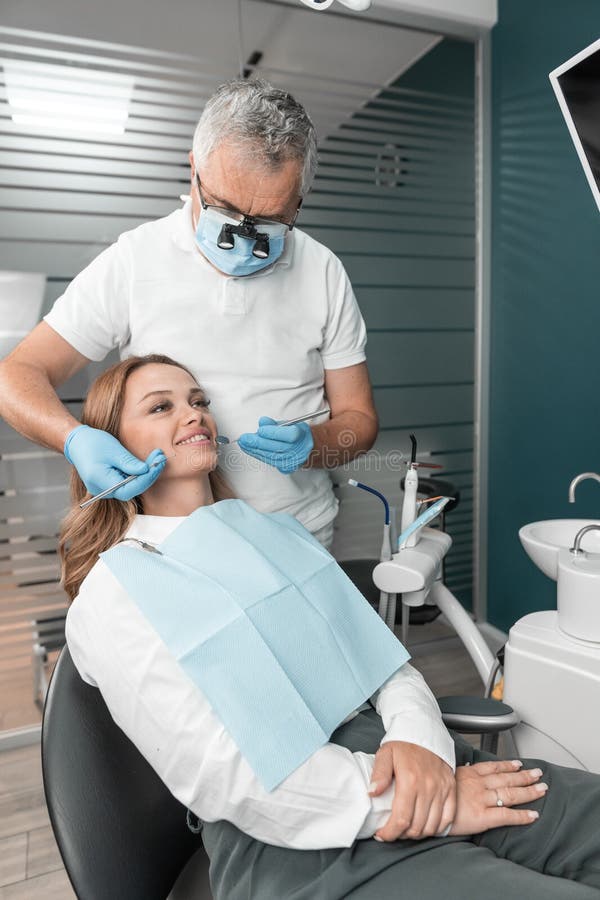 A women in a dental center for diagnostics by her experienced doctor. Patients receive personalized counseling and treatment from experienced professionals at the dental center. High quality photo. A women in a dental center for diagnostics by her experienced doctor. Patients receive personalized counseling and treatment from experienced professionals at the dental center. High quality photo