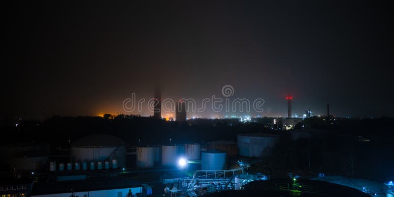 Eerie mist over a oil refinery at night. Eerie mist over a oil refinery at night.