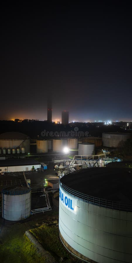 Gothenburg, Sweden - december 21 2022: Eerie mist over a oil refinery at night. Gothenburg, Sweden - december 21 2022: Eerie mist over a oil refinery at night.