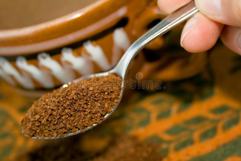 Spoon with coffee powder in the hand. Spoon with coffee powder in the hand