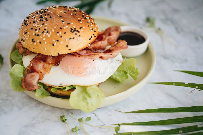 Egg Burger with Lettuce and Fried Bacon Stock Image Image of table