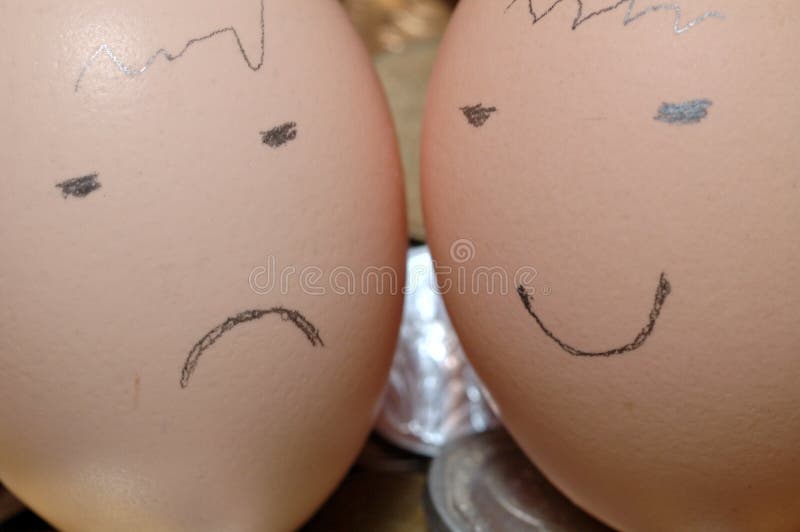 Happy and Sad Faces drawn on eggs with pencil. Happy and Sad Faces drawn on eggs with pencil.