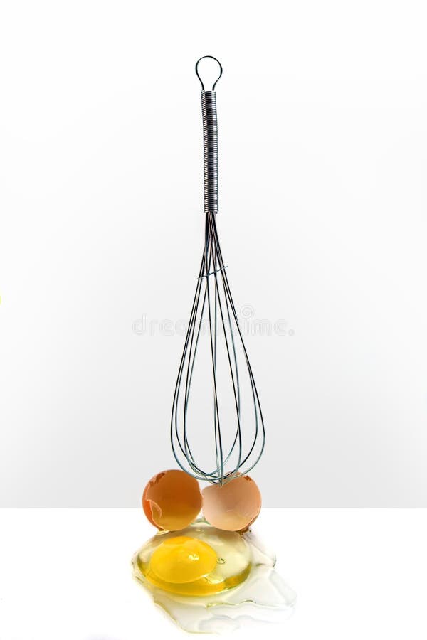 Egg in front of kitchen whisk