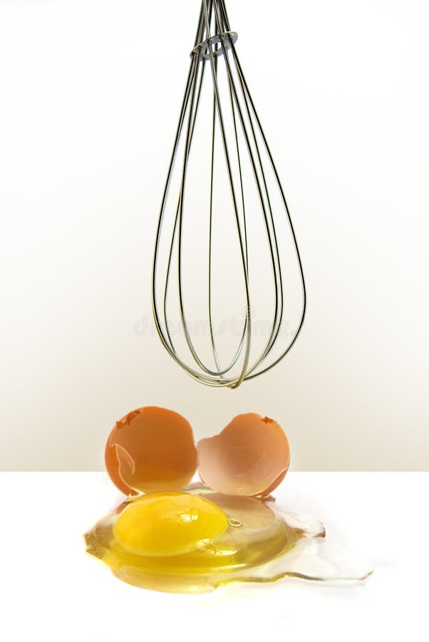 Egg in front of kitchen whisk