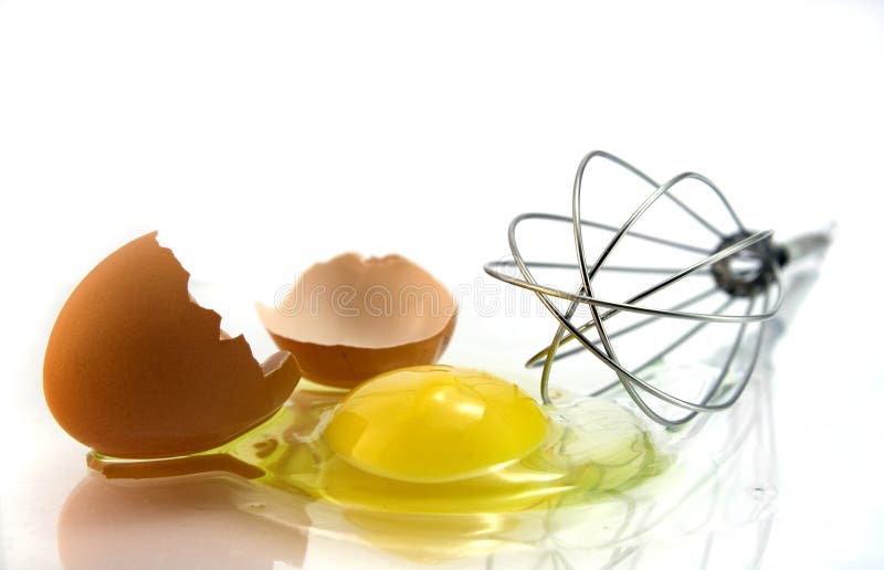 Egg in front of kitchen whisk