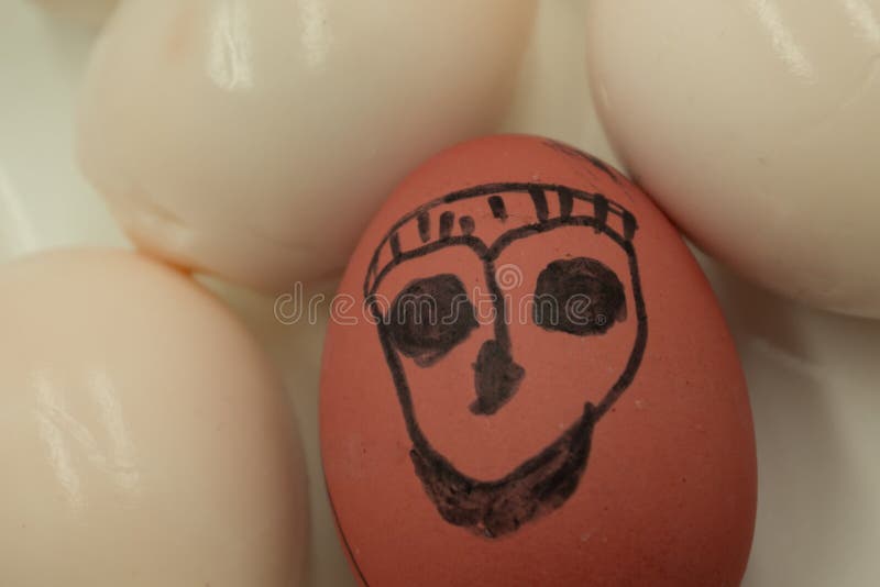 Egg with a frustrated face because of a crack in the co-shell and an egg with an evil face . stock photography Egg with a frustrated face because of a crack in the co-shell and an egg with an evil face . stock photography