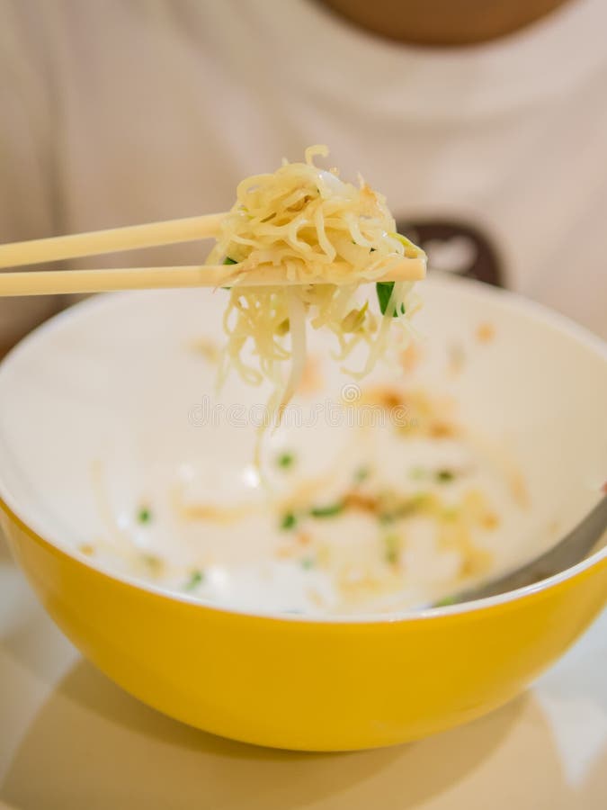 Yellow Noodles With Chopstick Holding Stock Photo Image of flavored, cuisine 34205910