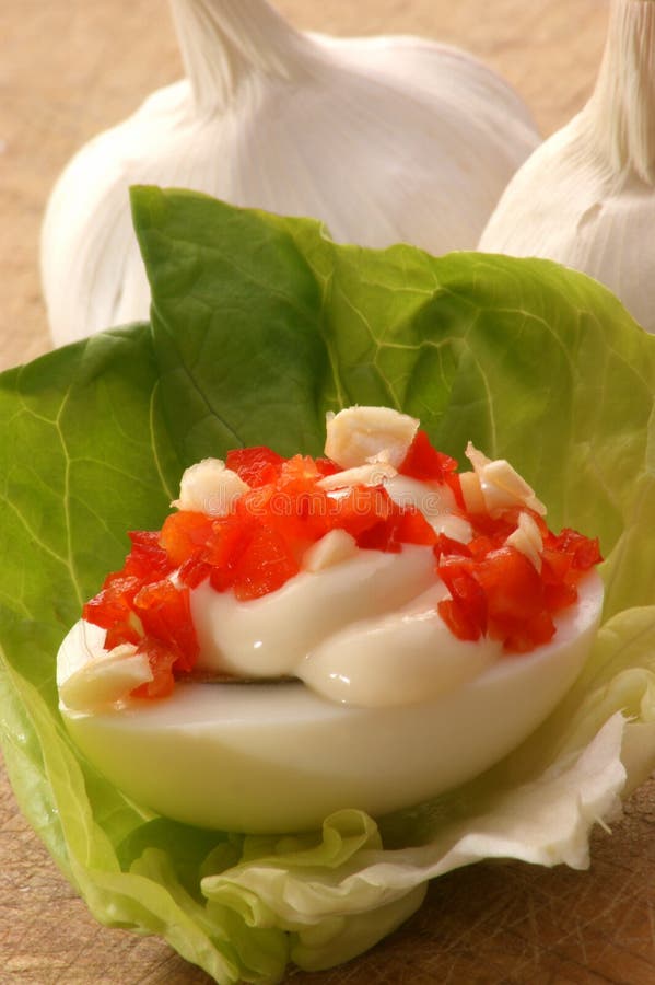 Egg with organic salad on a timber board