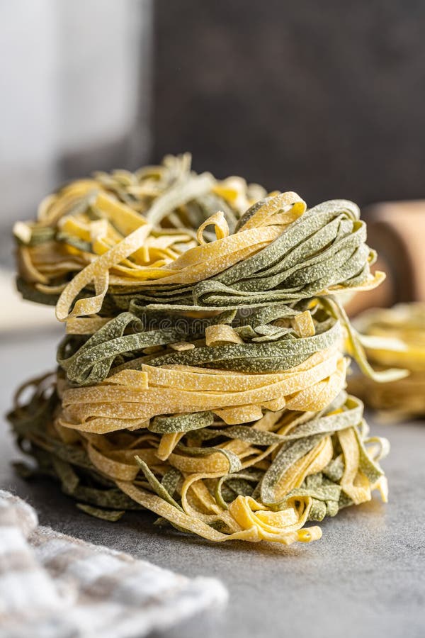 Egg Pasta. Noodles Nest with Spinach Flavor on Kitchen Table Stock