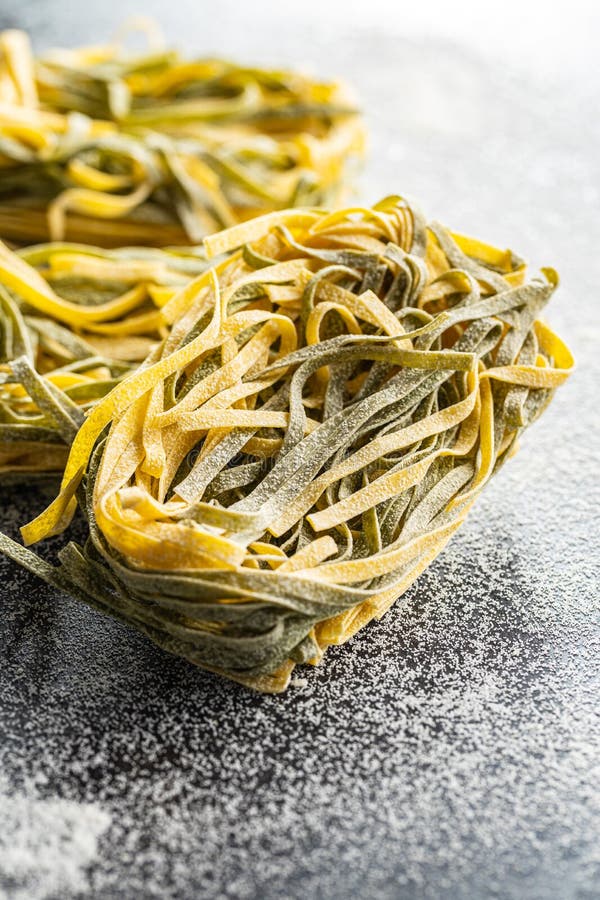 Egg Pasta. Noodles Nest with Spinach Flavor on Kitchen Table Stock