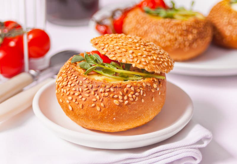 Egg Served in Bread Bowl. Breakfast Baked Eggs in Bread Bowls with the Fresh Herbs Stock Image