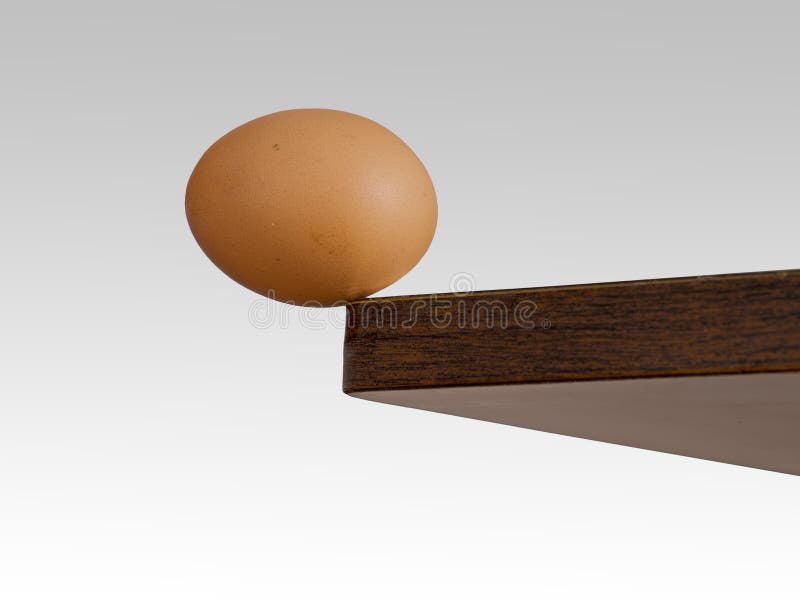Egg teetering on the edge. Brink. royalty free stock images Egg teetering on the edge. Brink. royalty free stock images