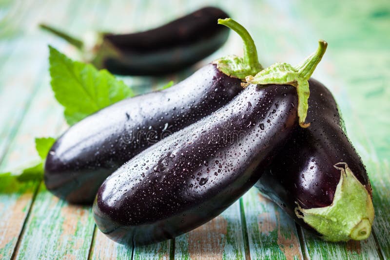 Eggplant. Fresh eggplant on the old wooden table stock images