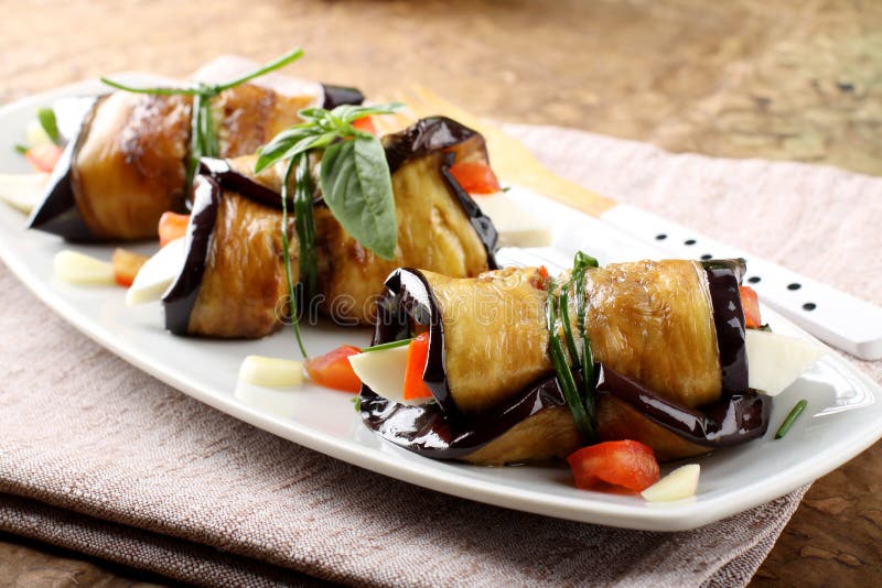 Eggplant rolls with cheese, tomato and basil