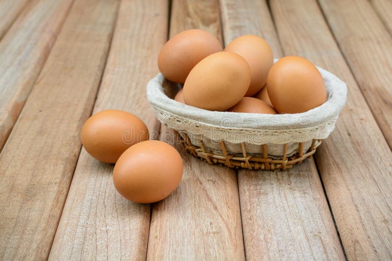 Eggs in basket on wooden background royalty free stock photos Eggs in basket on wooden background royalty free stock photos