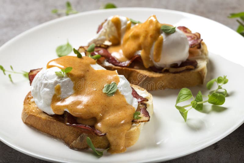 Eggs Benedict- toast, ham, poached eggs, and delicious buttery h royalty free stock images Eggs Benedict- toast, ham, poached eggs, and delicious buttery h royalty free stock images
