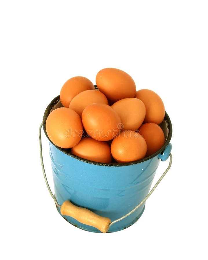 Eggs in blue old metal bucket isolated on white