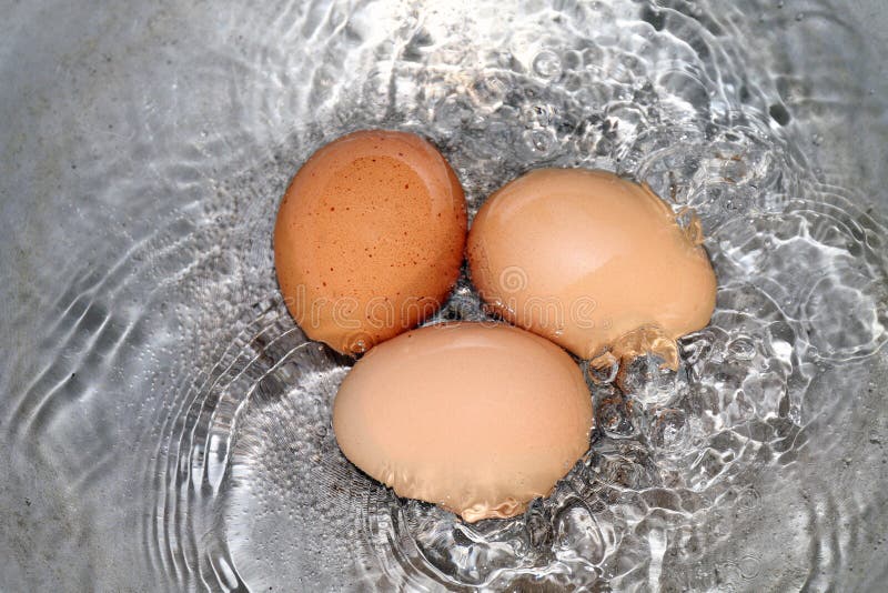 Eggs, Boiled Egg in the Pan, Raw Egg Reddish Yellow in Hot Water is Boiling Cooking Selective