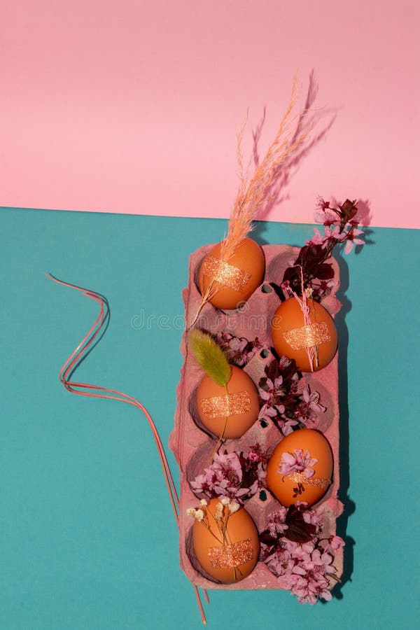 Eggs Decorated with Flowers in an Egg Box on a Pinkblue Background