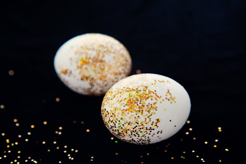 Eggs Decorated with Gold Glitter on Dark Background. Easter Concept