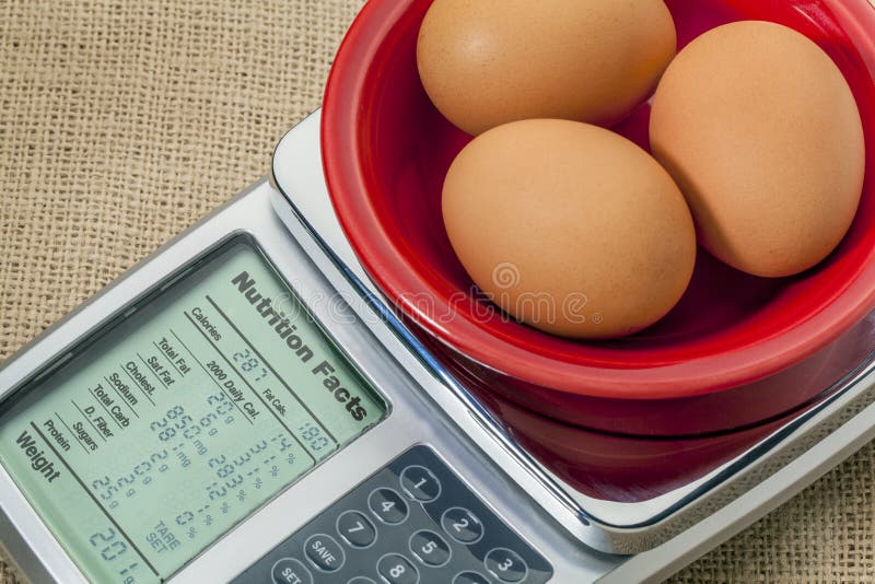 Three eggs on diet scale displaying nutrition facts - a diet concept