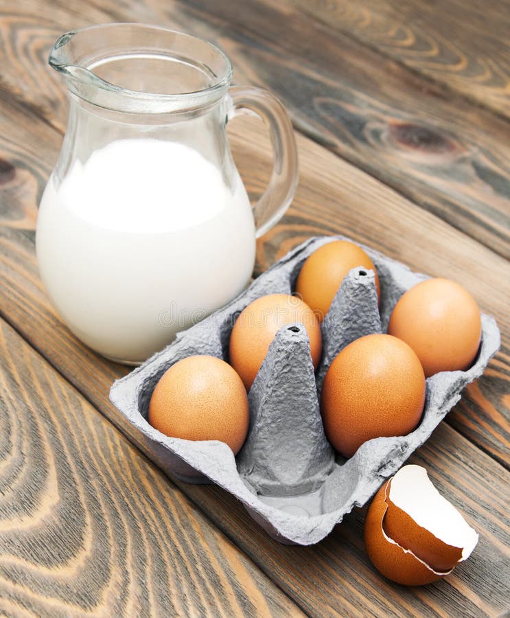 Eggs and milk on a old wooden background