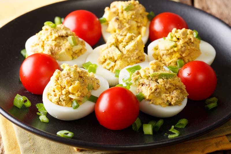 Eggs Stuffed with Canned Tuna and Avocado with Tomatoes and Green