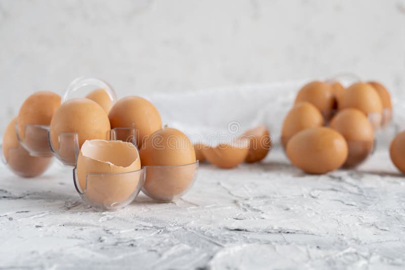 Eggs on the Table with Cracked in a Half One, Yolk and Protein in