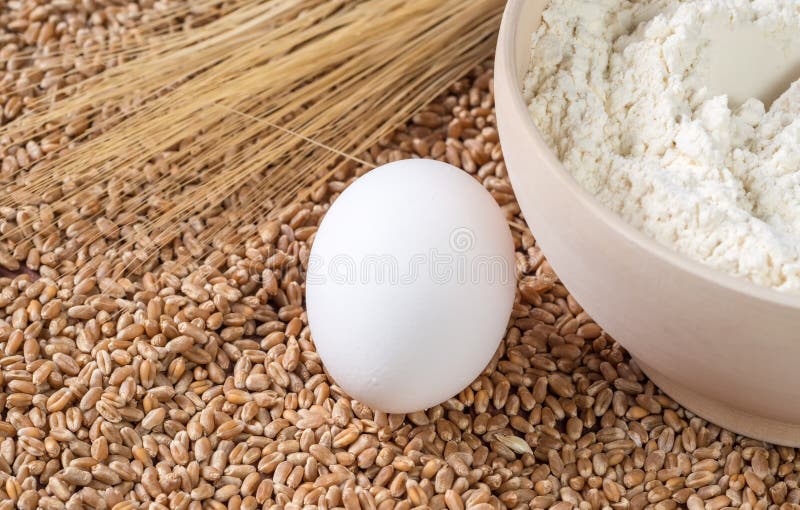 Flour, Eggs, Wheat Ears on a Background of Grains. Stock Image Image