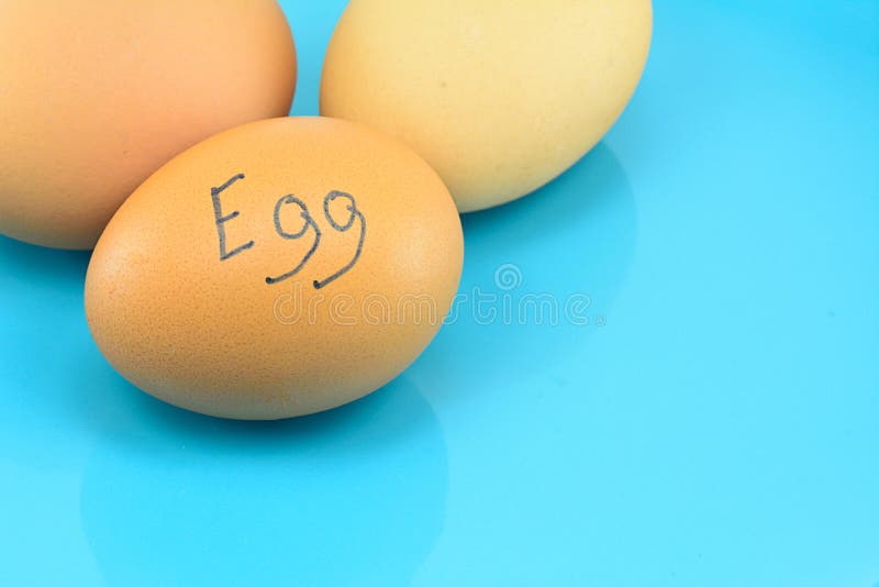Eggs with Word Egg on Blue Plate for Food Concept Stock Photo Image