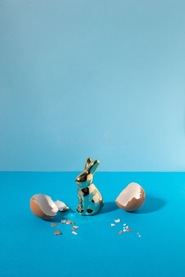 Eggshell with bunny rabbit. Creative copy space on pastel blue background. Minimal Easter holiday concept royalty free stock images