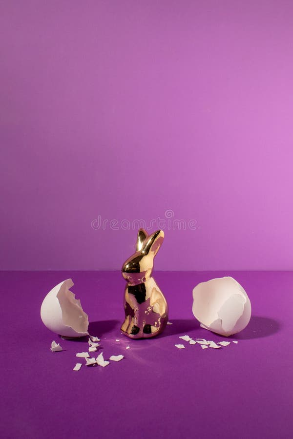 Eggshell with bunny rabbit. Creative copy space on pastel purple background. Minimal Easter holiday concept royalty free stock image