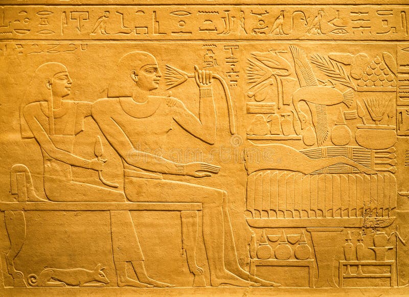 Egyptian hieroglyphs carved on clay royalty free stock photo