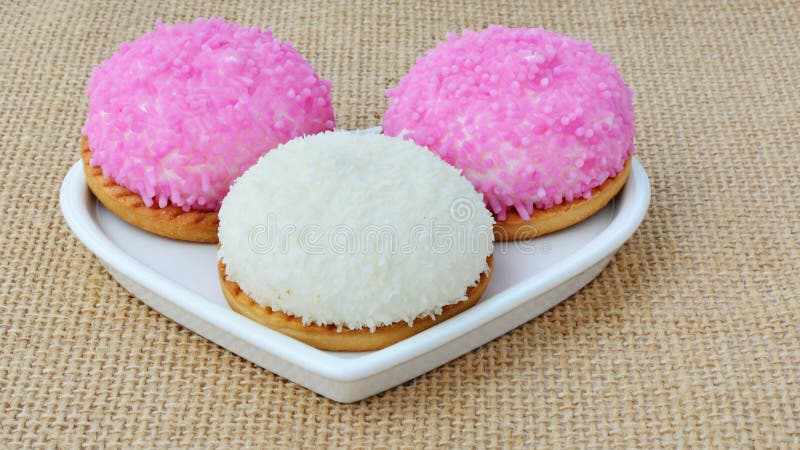Eibischkekse mit rosa Zucker besprüht und zerriss Kokosnuss stockfotos Eibischkekse mit rosa Zucker besprüht und zerriss Kokosnuss stockfotos