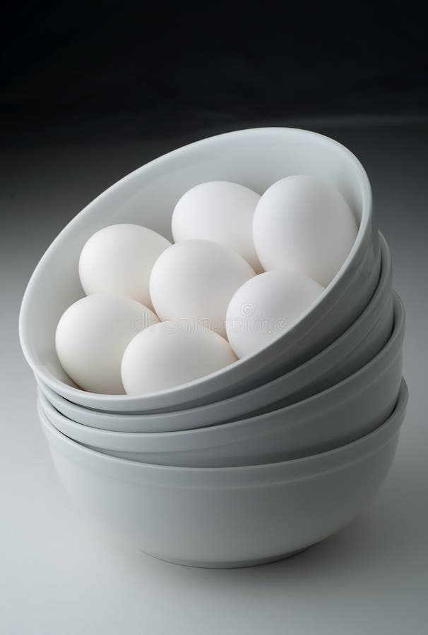 Eggs in stacked white bowls with graduated background. Eggs in stacked white bowls with graduated background