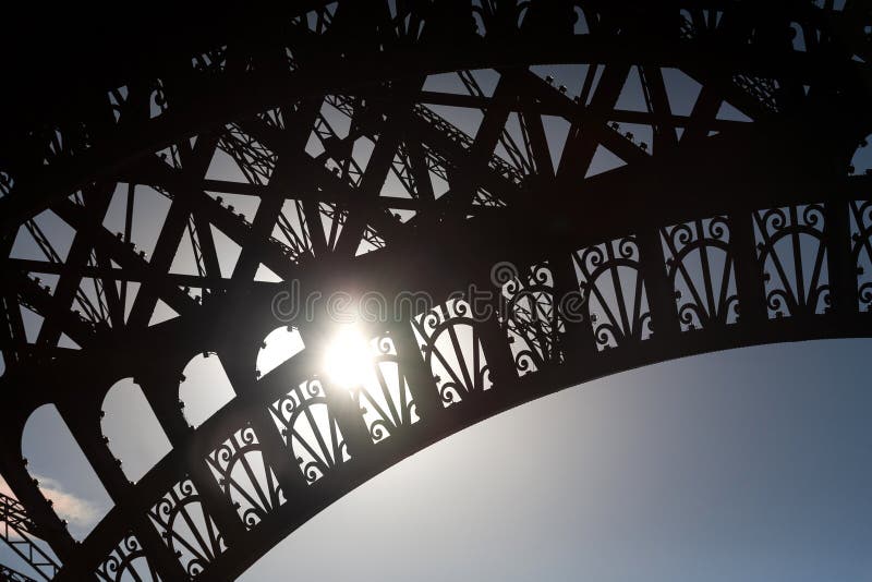 Eiffel Tower detail showing patterns and sun stock photo Eiffel Tower detail showing patterns and sun stock photo