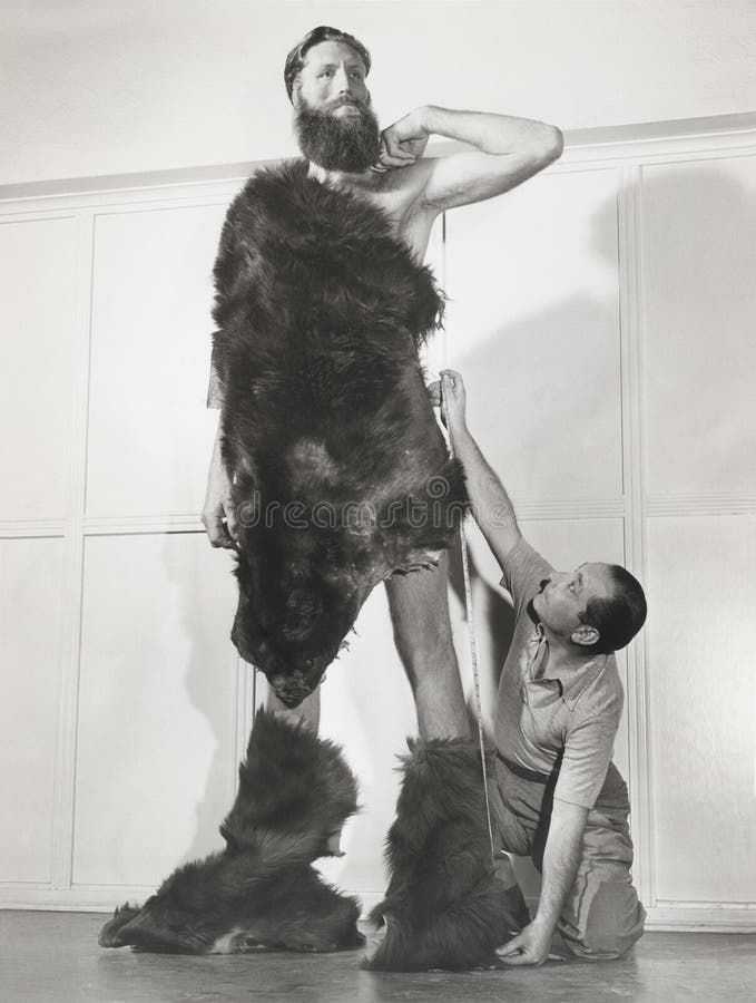 Eight Foot Man Measured for Custom Tailored Fur Suit Stock Photo