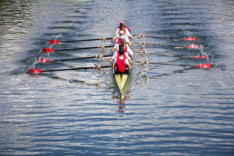 Eight men rowing