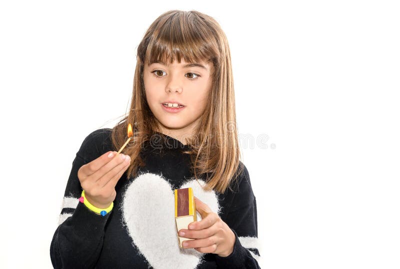 Eight year old girl playing with matches isolated on white